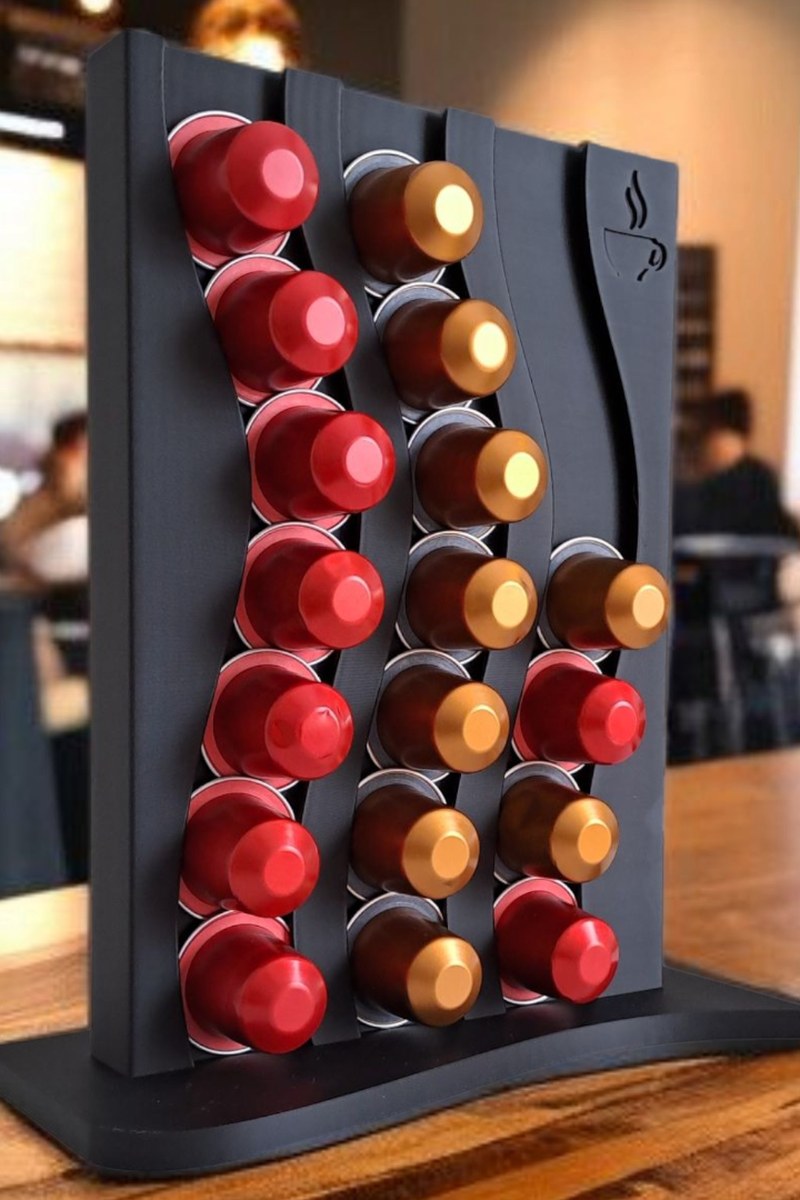 Wavy nespresso capsule holder filled with assorted coffee capsules, close-up view of textured surface