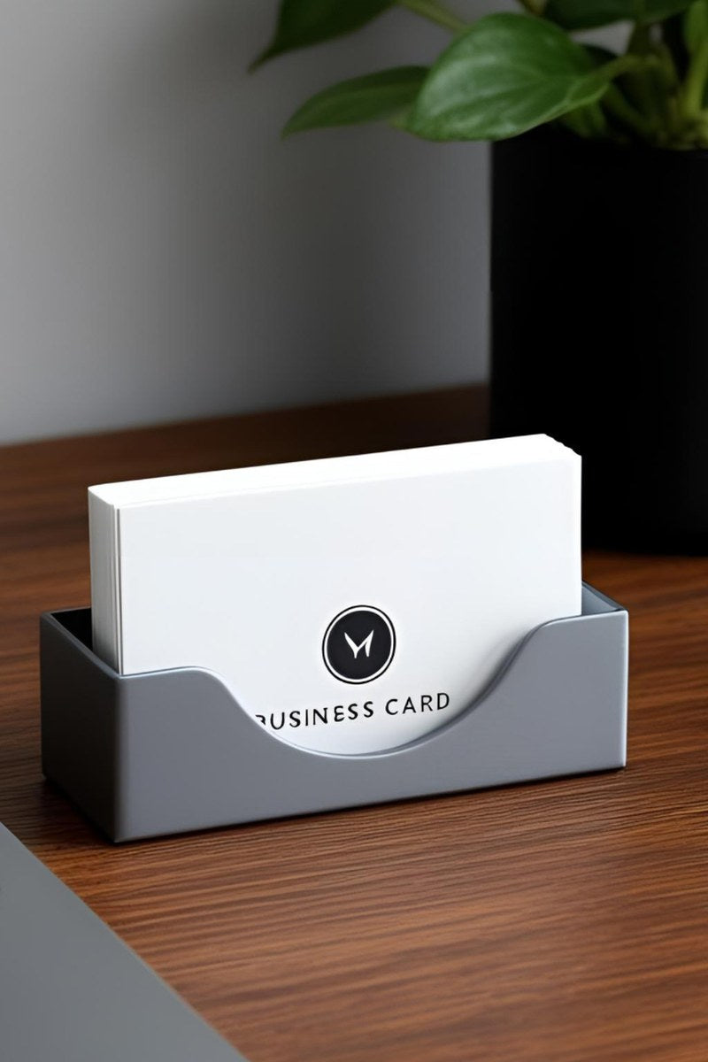 Minimalist business card holder in white, close-up view showing clean geometric form