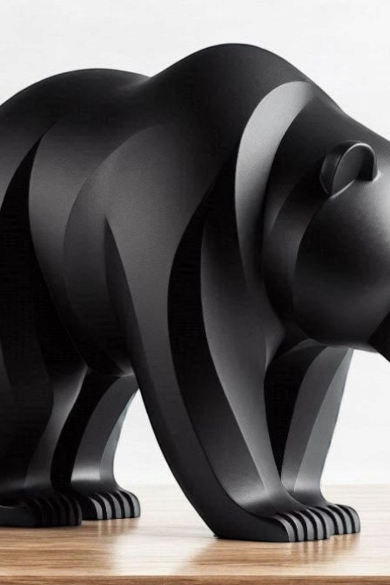 Close-up of minimalist bear sculpture showing curved lines and smooth surface