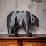 Minimalist bear sculpture positioned on a shelf with muted decor