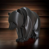Close-up of minimalist bear sculpture showing curved lines and smooth surface
