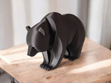 Close-up of minimalist bear sculpture showing curved lines and smooth surface
