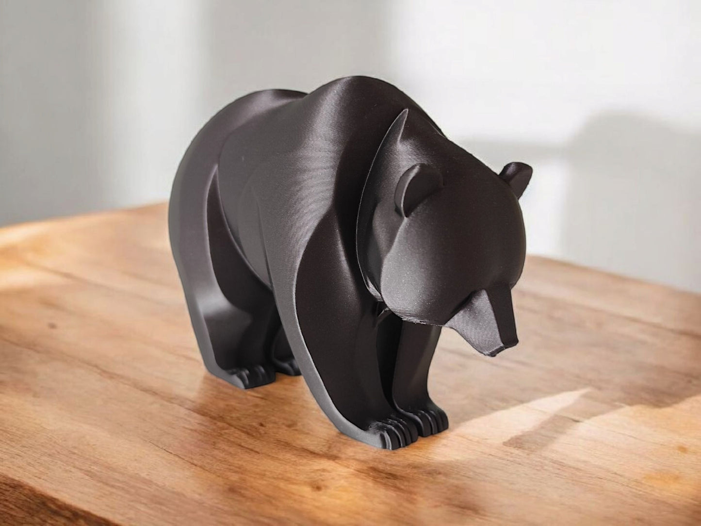 Close-up of minimalist bear sculpture showing curved lines and smooth surface