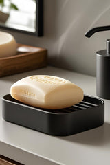 White soap holder with ribbed drainage pattern, close-up view
