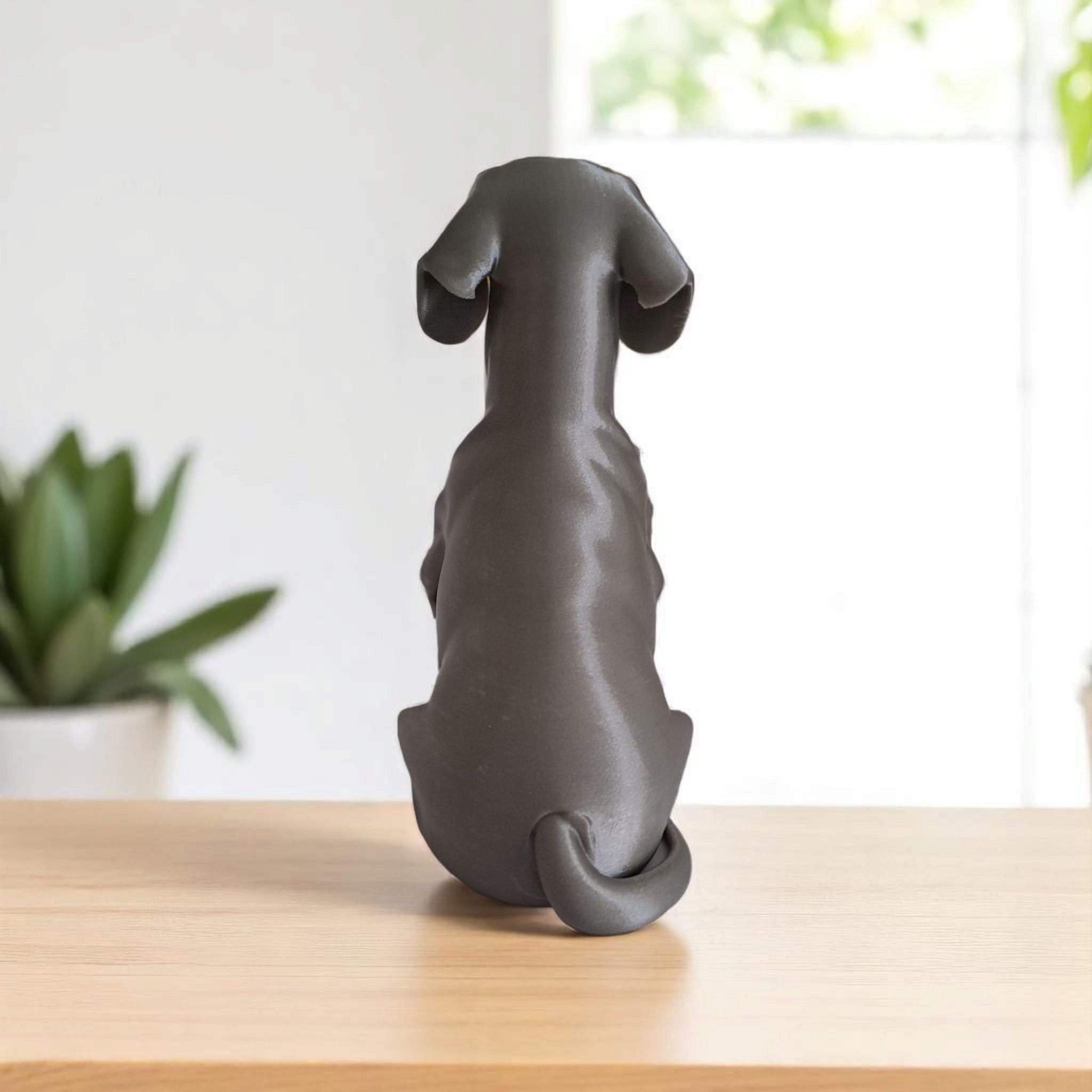 Minimalist dachshund sculpture with clean geometric form, side view