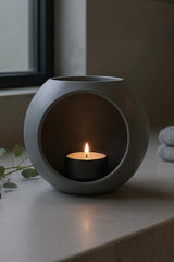 Spherical LED tealight holder in white, close-up showing smooth geometric form