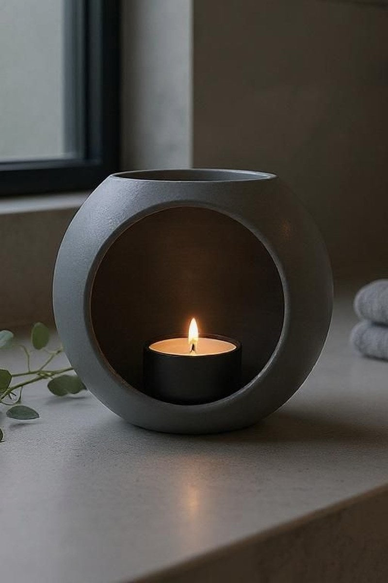 Spherical LED tealight holder in white, close-up showing smooth geometric form