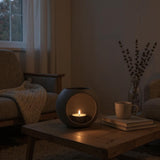 Modern LED tealight holder on shelf with warm candlelight glowing inside