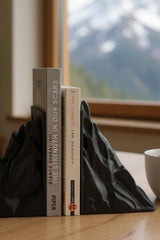 Minimalist mountain bookend, geometric form in soft finish, close-up detail