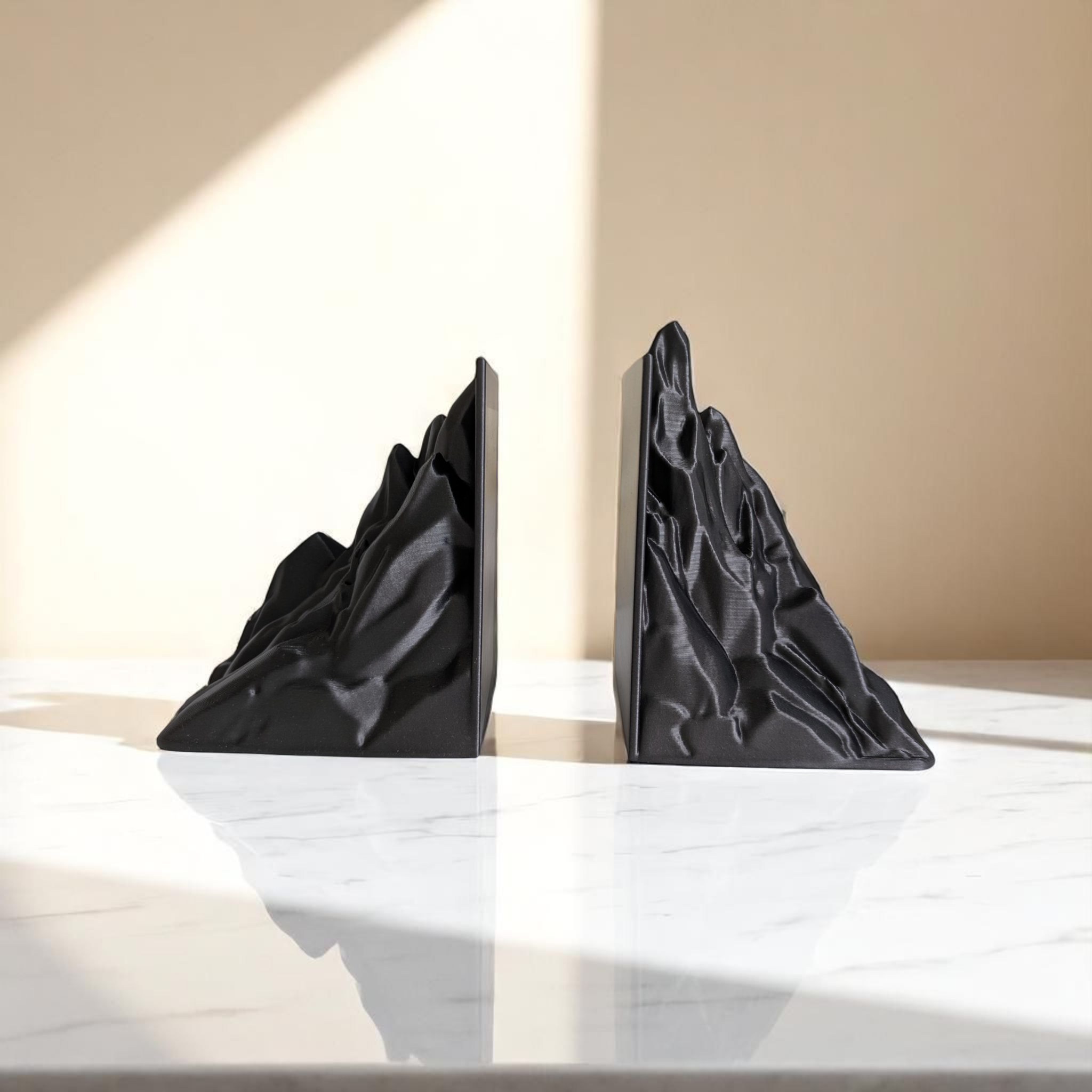 Minimalist mountain bookend, geometric form in soft finish, close-up detail