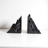 Minimalist mountain bookend, geometric form in soft finish, close-up detail