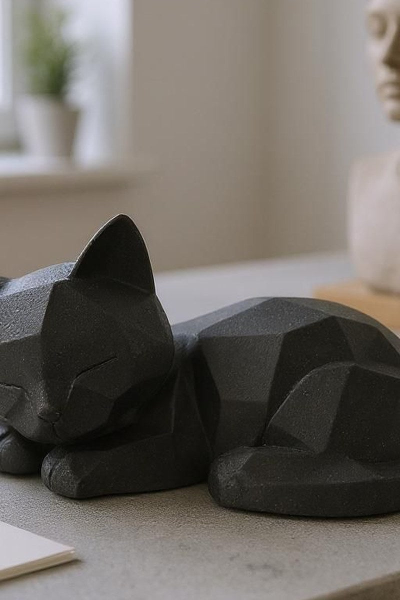 Close-up of sleeping low poly kitten showing geometric facets and smooth surface
