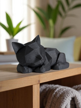 Cute low poly kitten figurine displayed on wooden shelf with plants