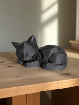 Close-up of sleeping low poly kitten showing geometric facets and smooth surface