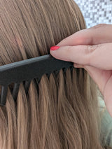 Detangle comb in light bathroom setting on white surface