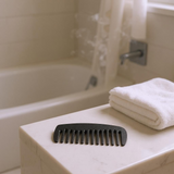 Detangle hair comb with alternating long and short staggered teeth, close-up view