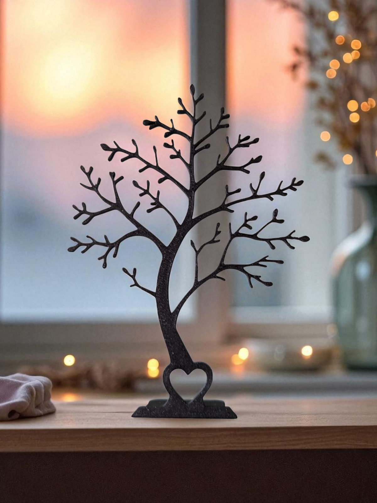 Minimalist tree stand displayed on a white shelf with neutral home decor