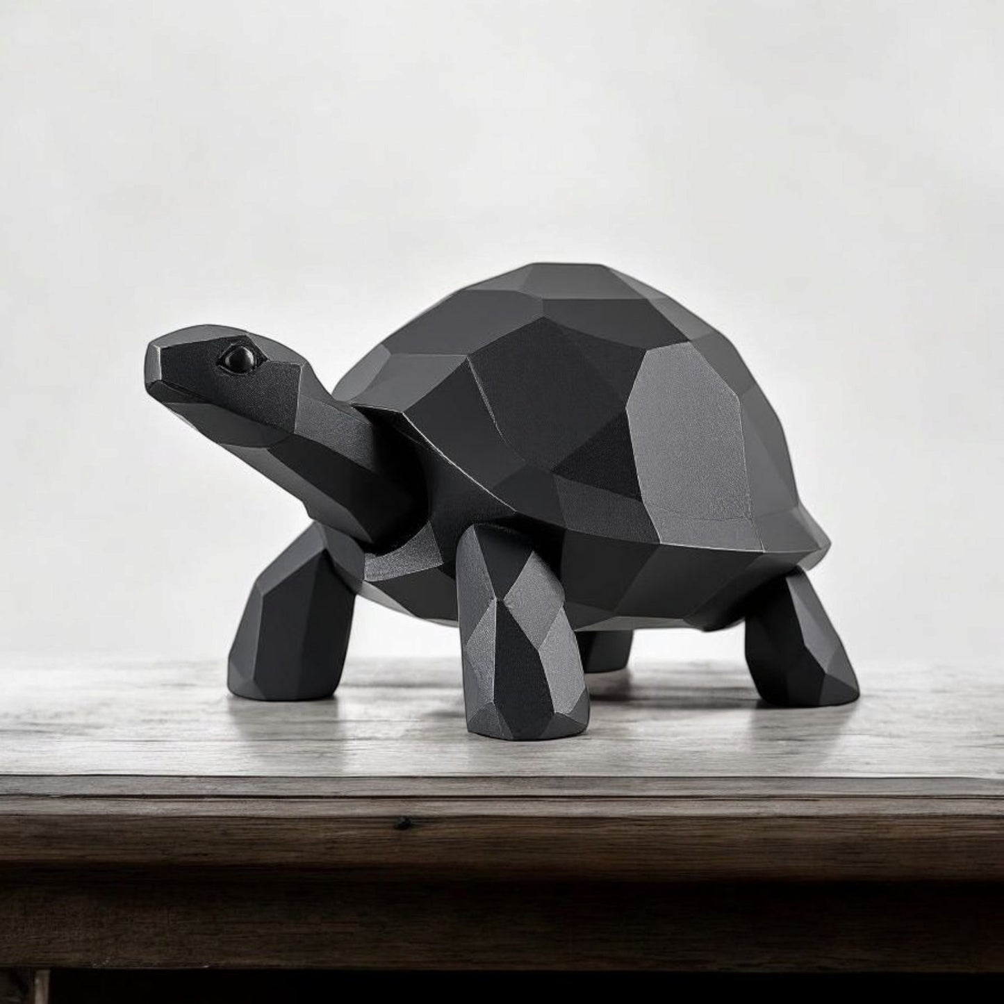 Low poly turtle sculpture positioned on wooden shelf in minimalist interior setting