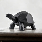 Low poly turtle sculpture positioned on wooden shelf in minimalist interior setting