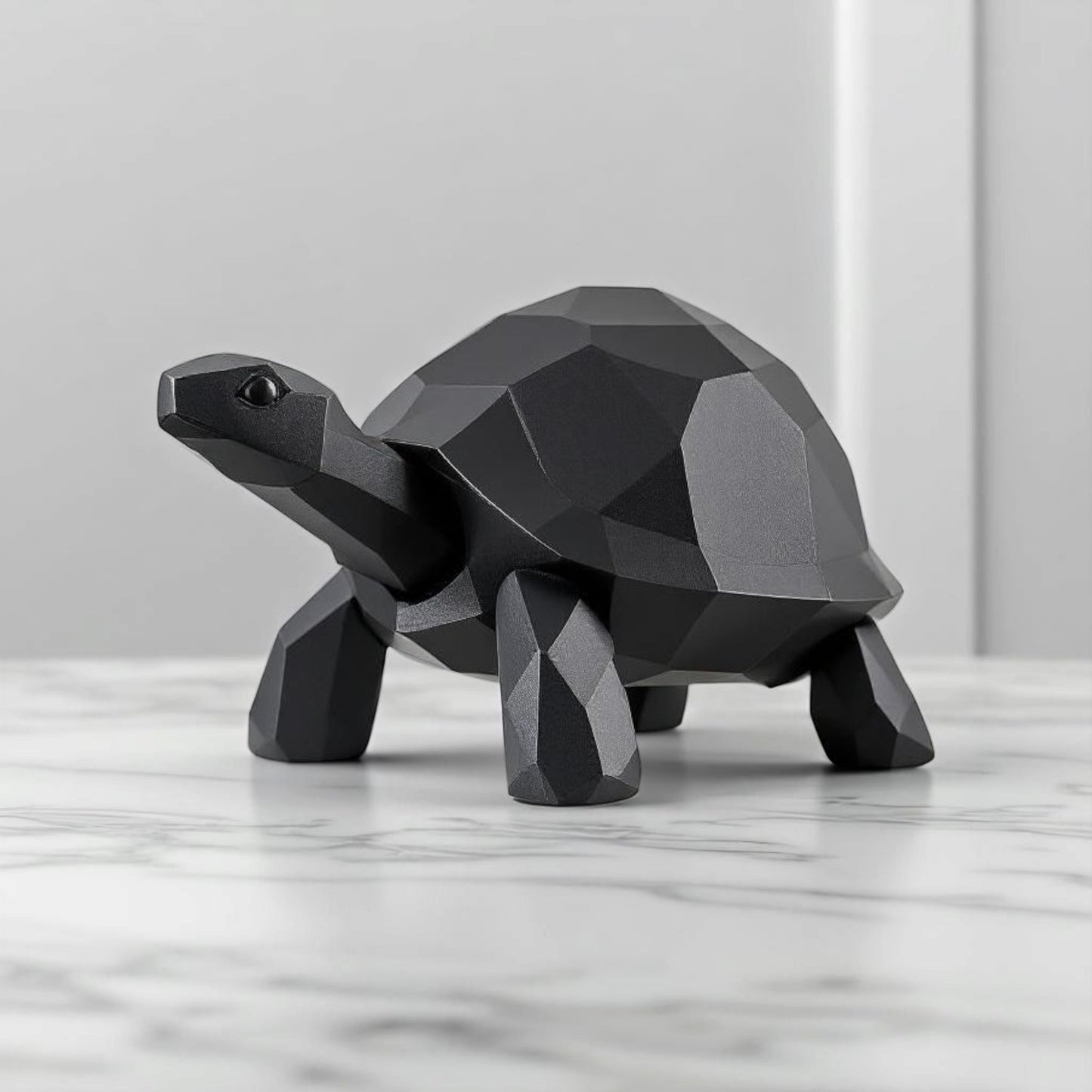 Close-up of low poly turtle sculpture showing geometric faceted surface and clean lines