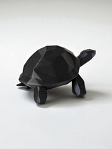 Close-up of low poly turtle sculpture showing geometric faceted surface and clean lines