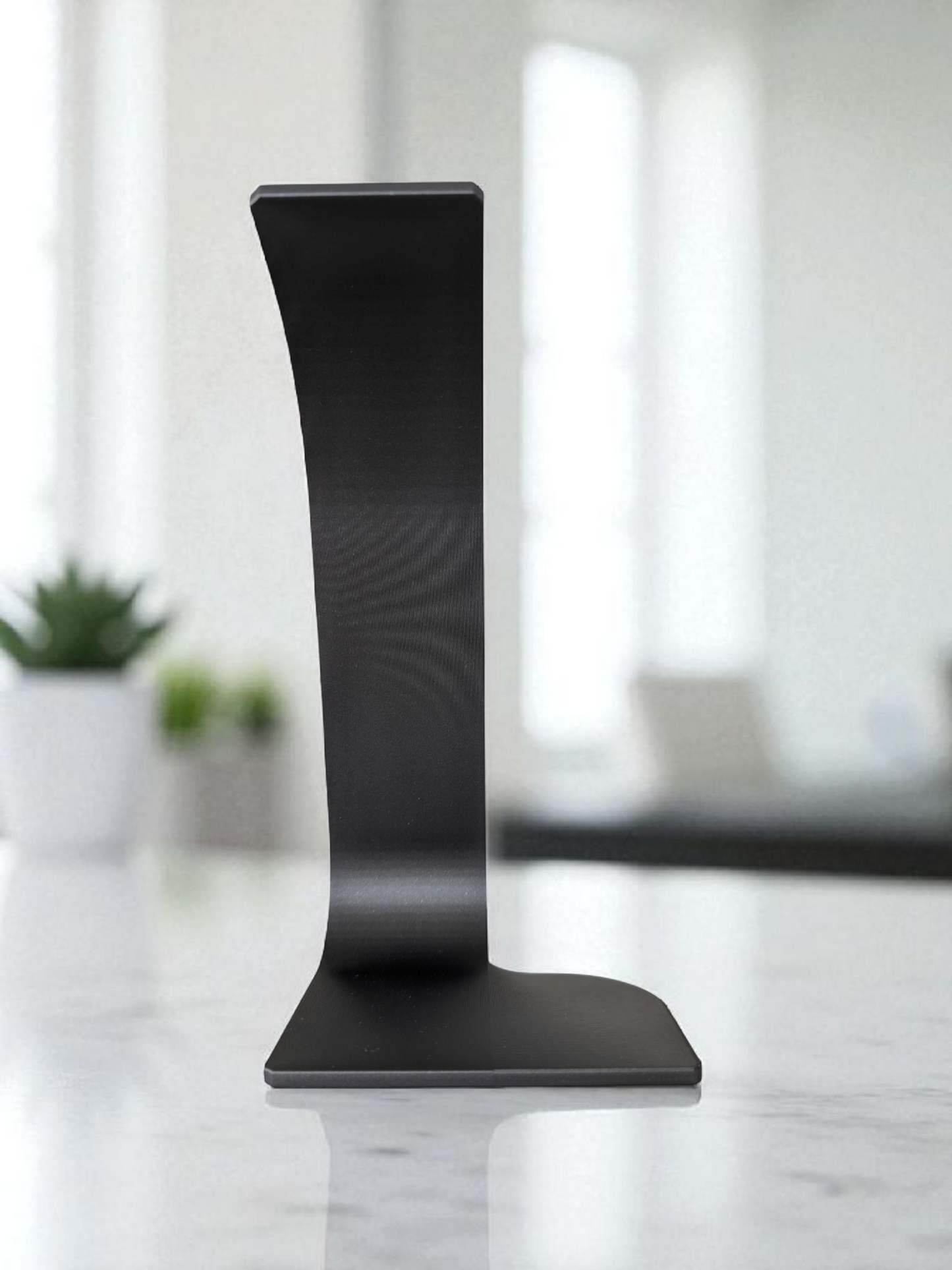 Swing headphone stand viewed from the side, showing curved cantilever arm and stable base