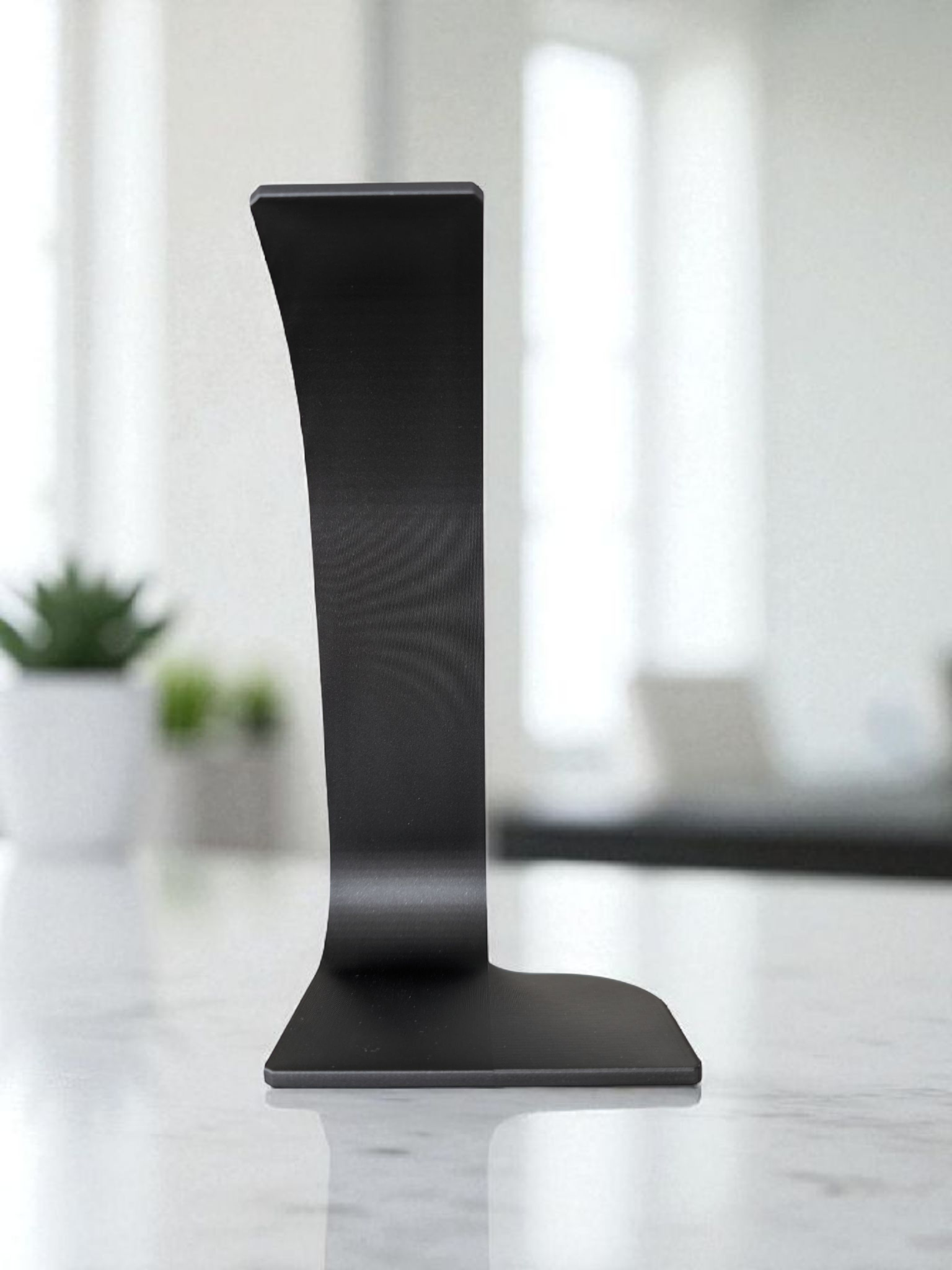 Swing headphone stand viewed from the side, showing curved cantilever arm and stable base