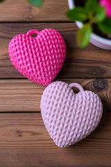 Close-up of knitted heart keychain showing textured surface and soft detail