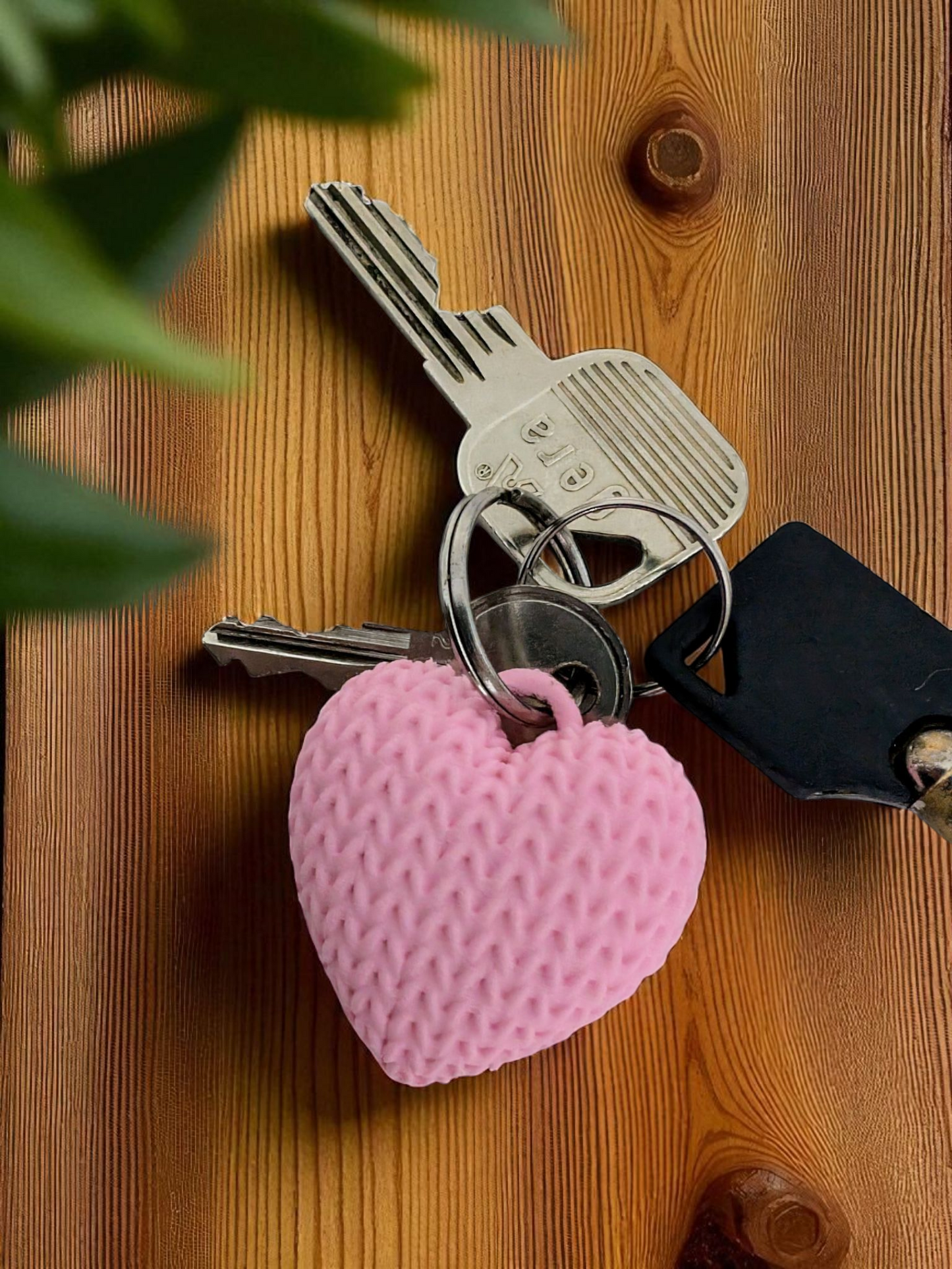 Knitted heart keychain attached to keys in neutral tones