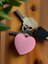 Knitted heart keychain attached to keys in neutral tones