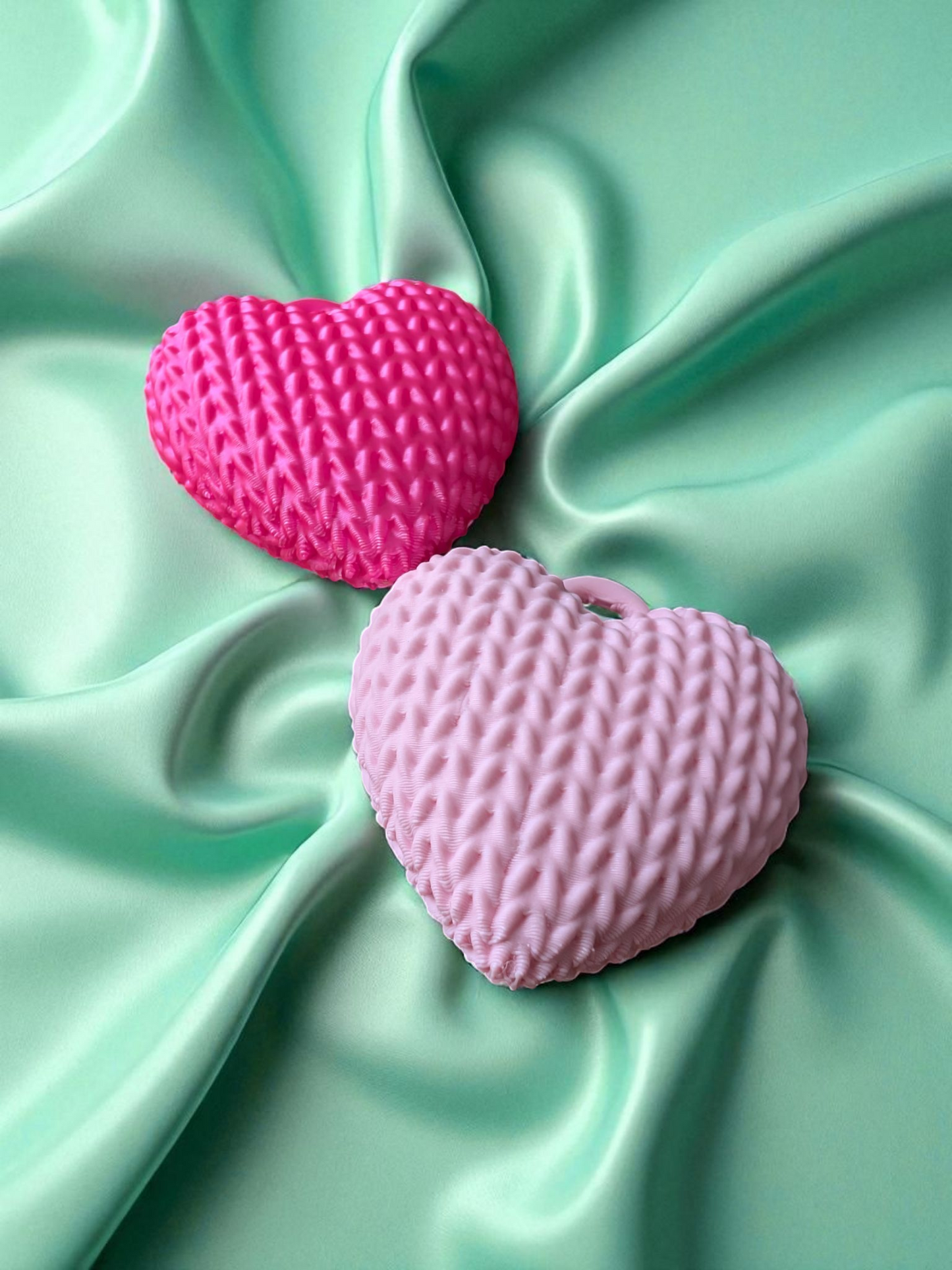 Close-up of knitted heart keychain showing textured surface and soft detail