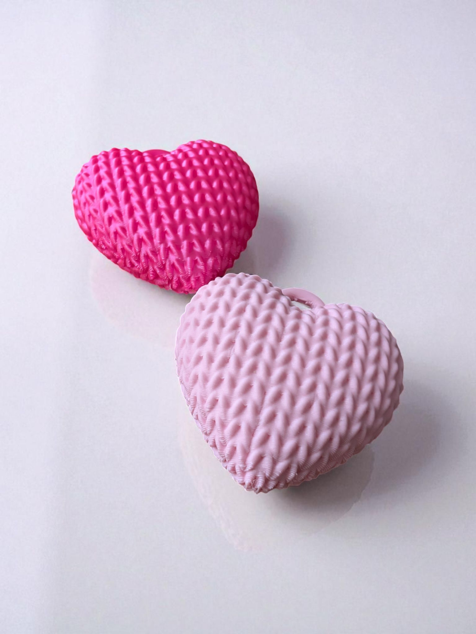 Close-up of knitted heart keychain showing textured surface and soft detail
