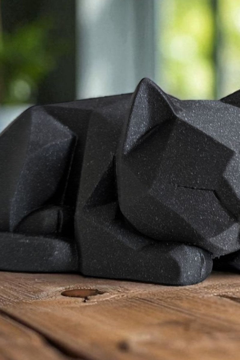 Close-up of low poly cat figurine showing geometric plane details