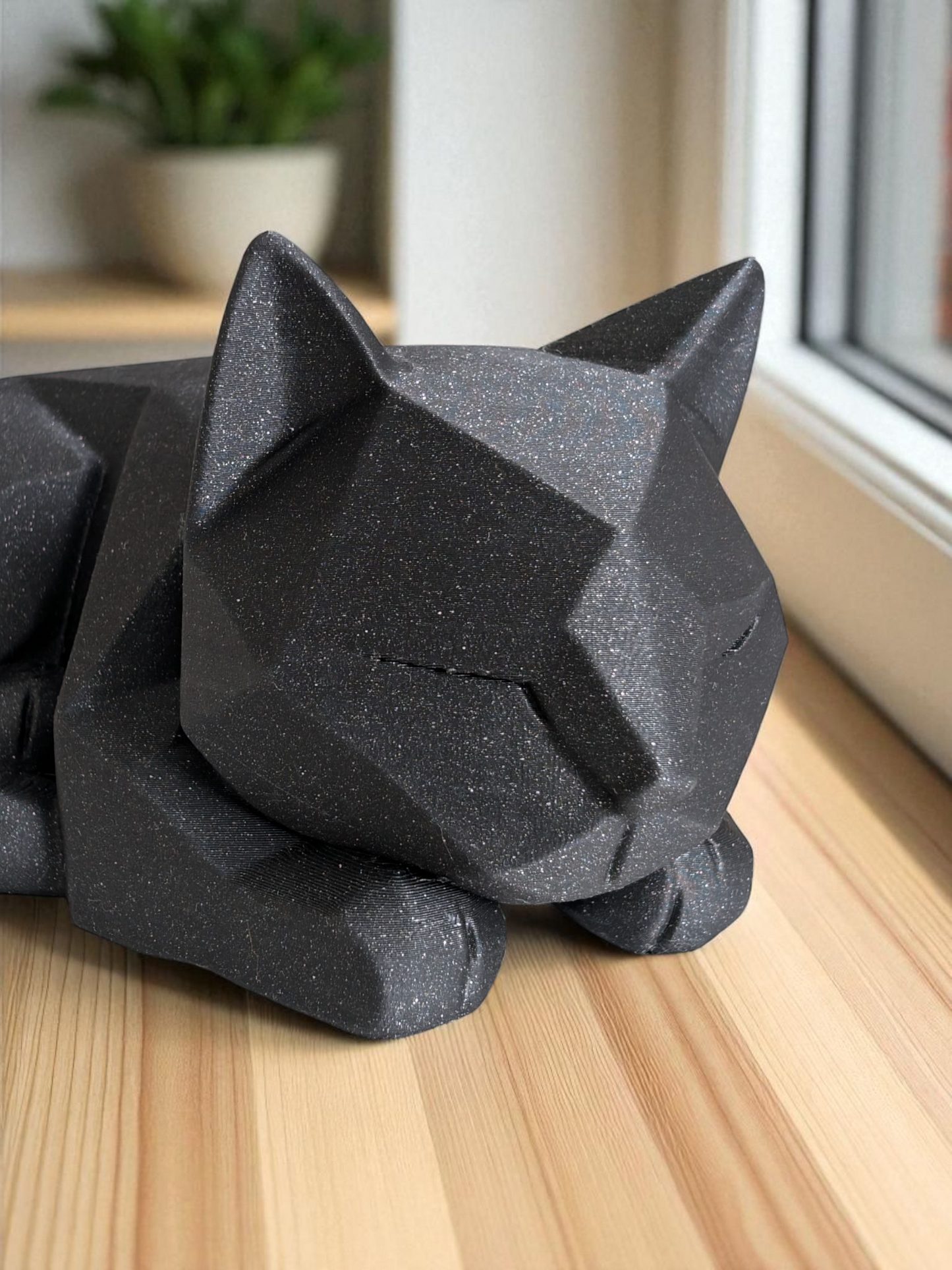Detail of angular facets on waiting cat figurine's head and body