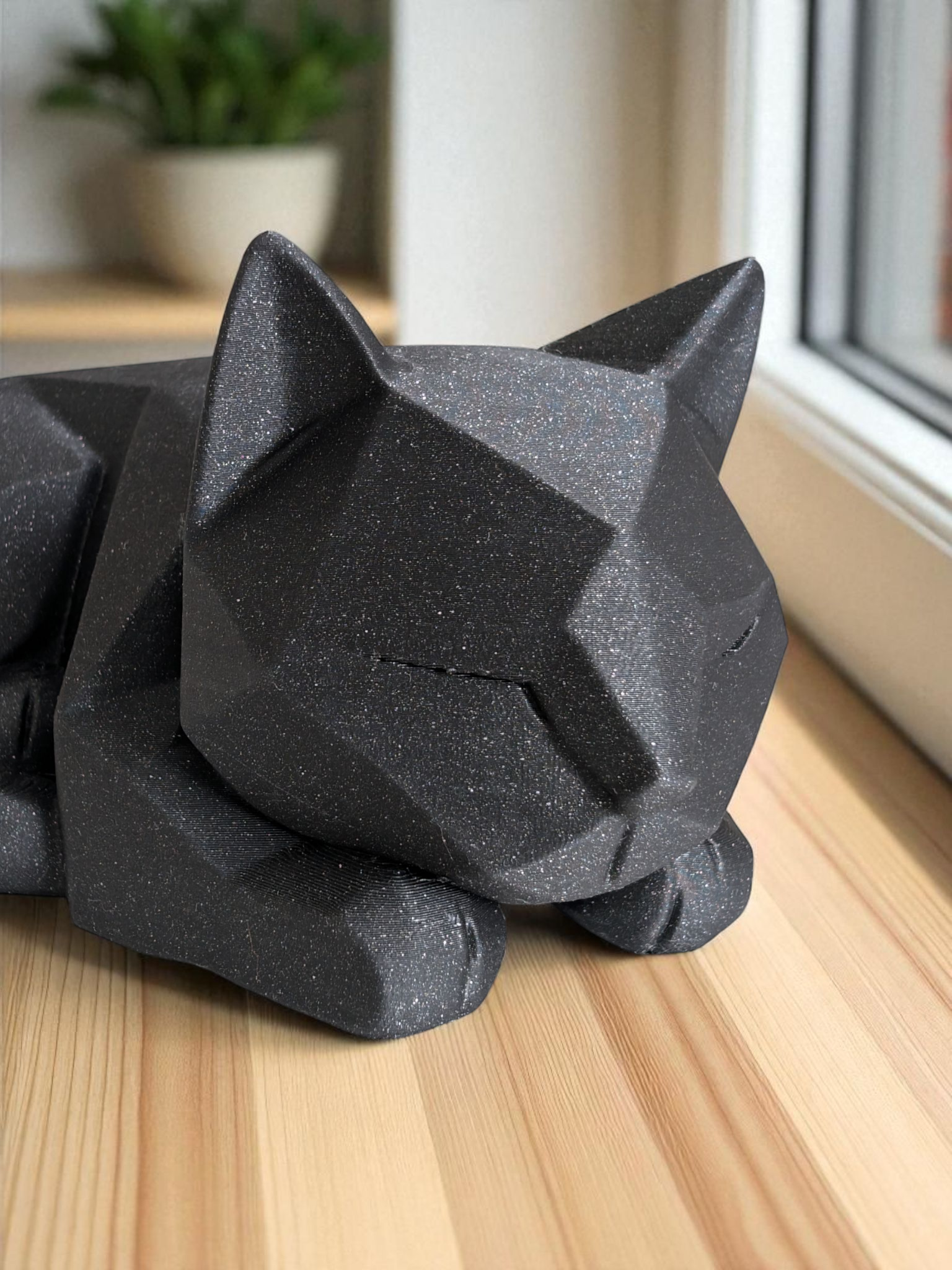 Detail of angular facets on waiting cat figurine's head and body