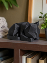 Close-up of low poly cat figurine showing geometric plane details
