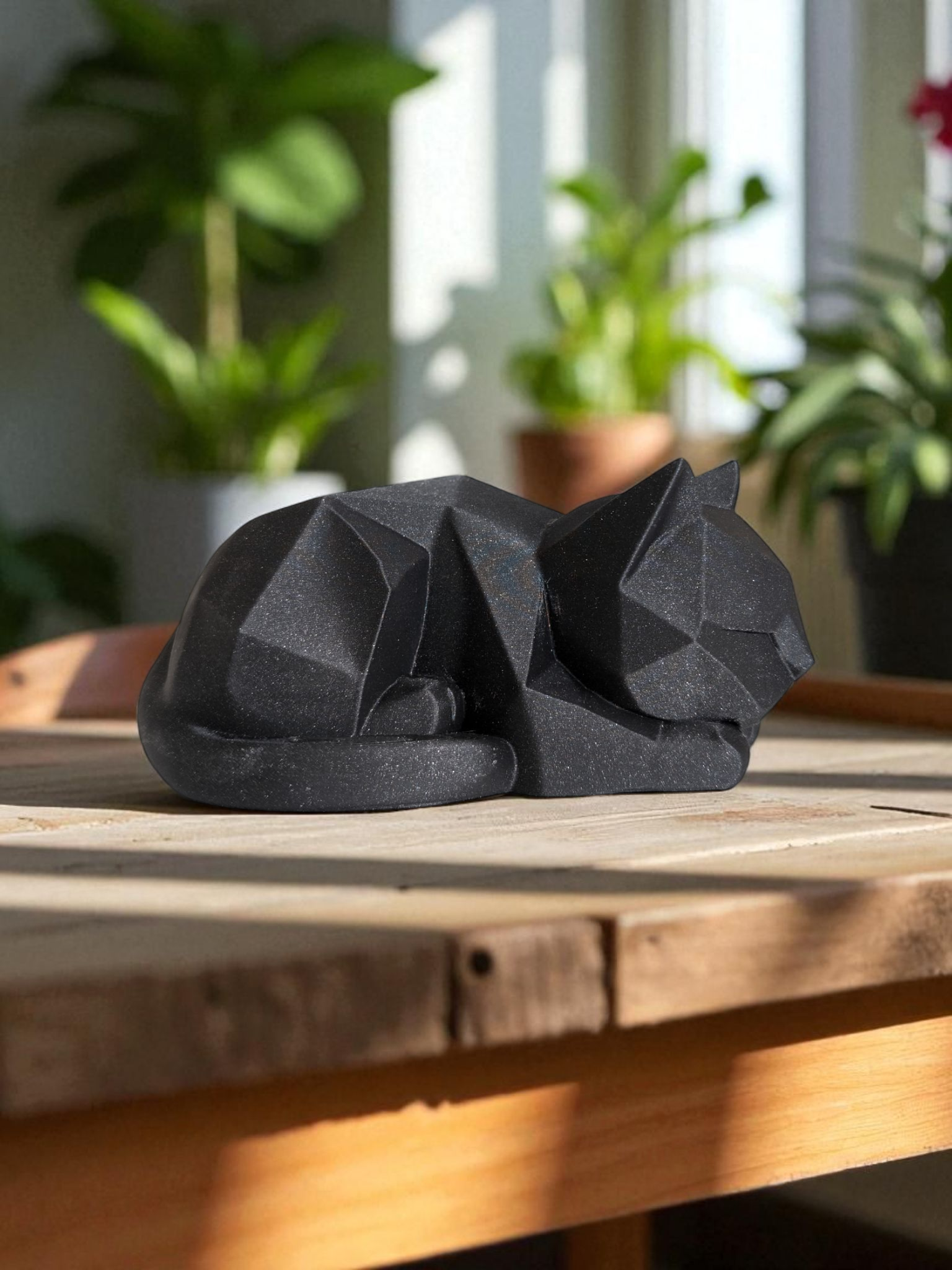 Close-up of low poly cat figurine showing geometric plane details