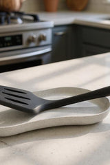 Minimalist white spoon rest with shallow tray design, close-up view