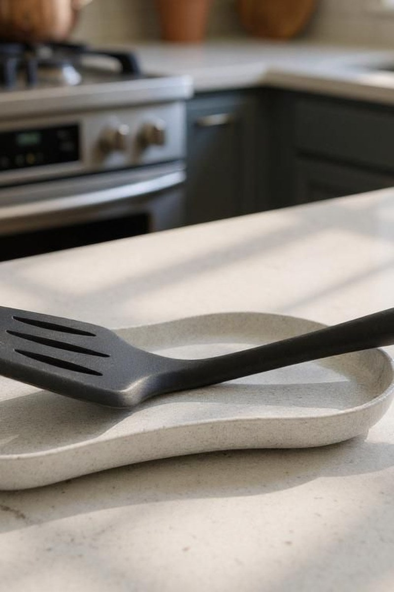 Minimalist white spoon rest with shallow tray design, close-up view