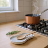 Minimalist white spoon rest with shallow tray design, close-up view