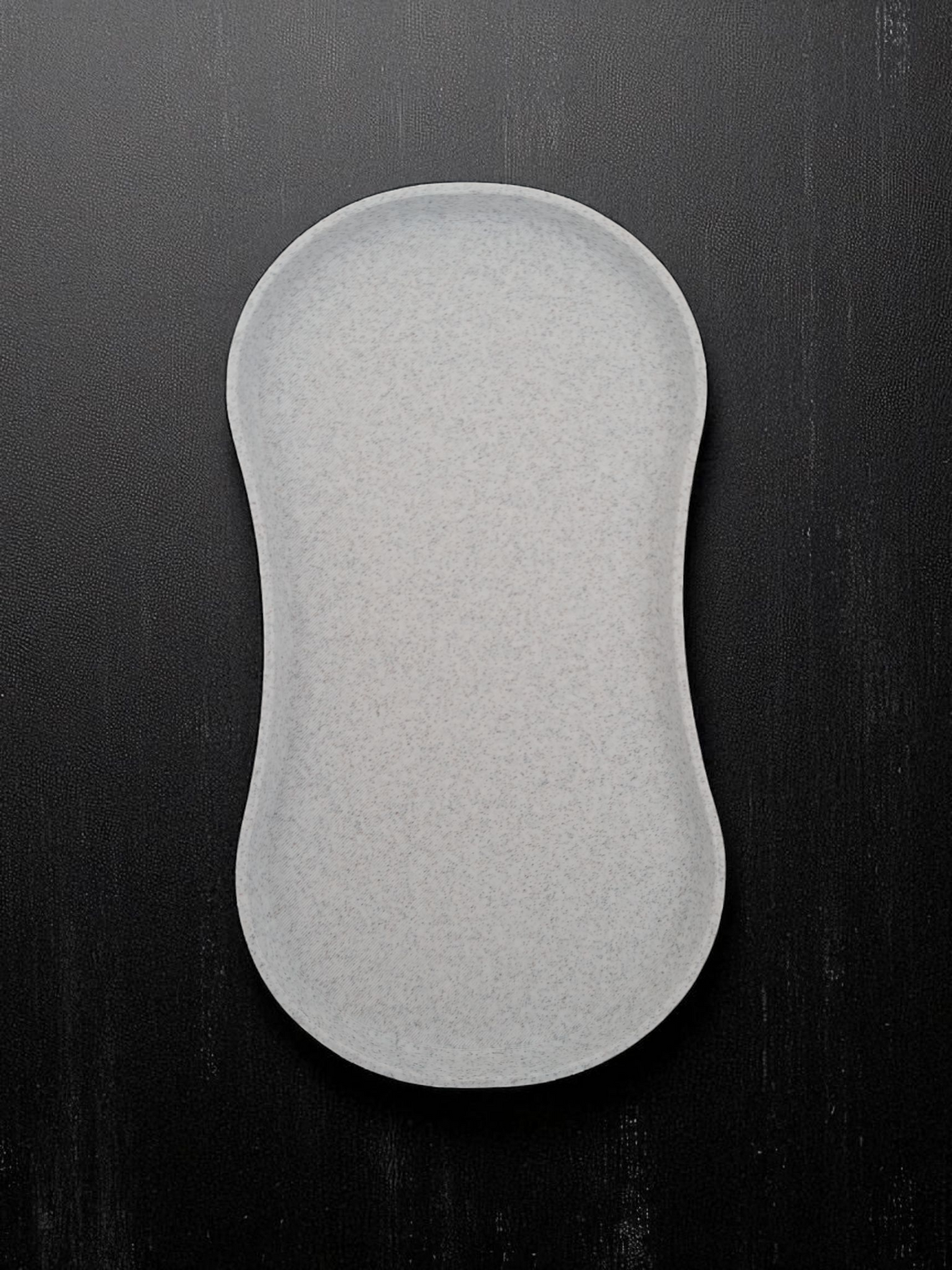 Minimalist white spoon rest with shallow tray design, close-up view