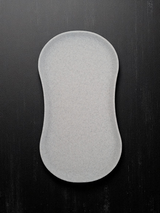 Minimalist white spoon rest with shallow tray design, close-up view