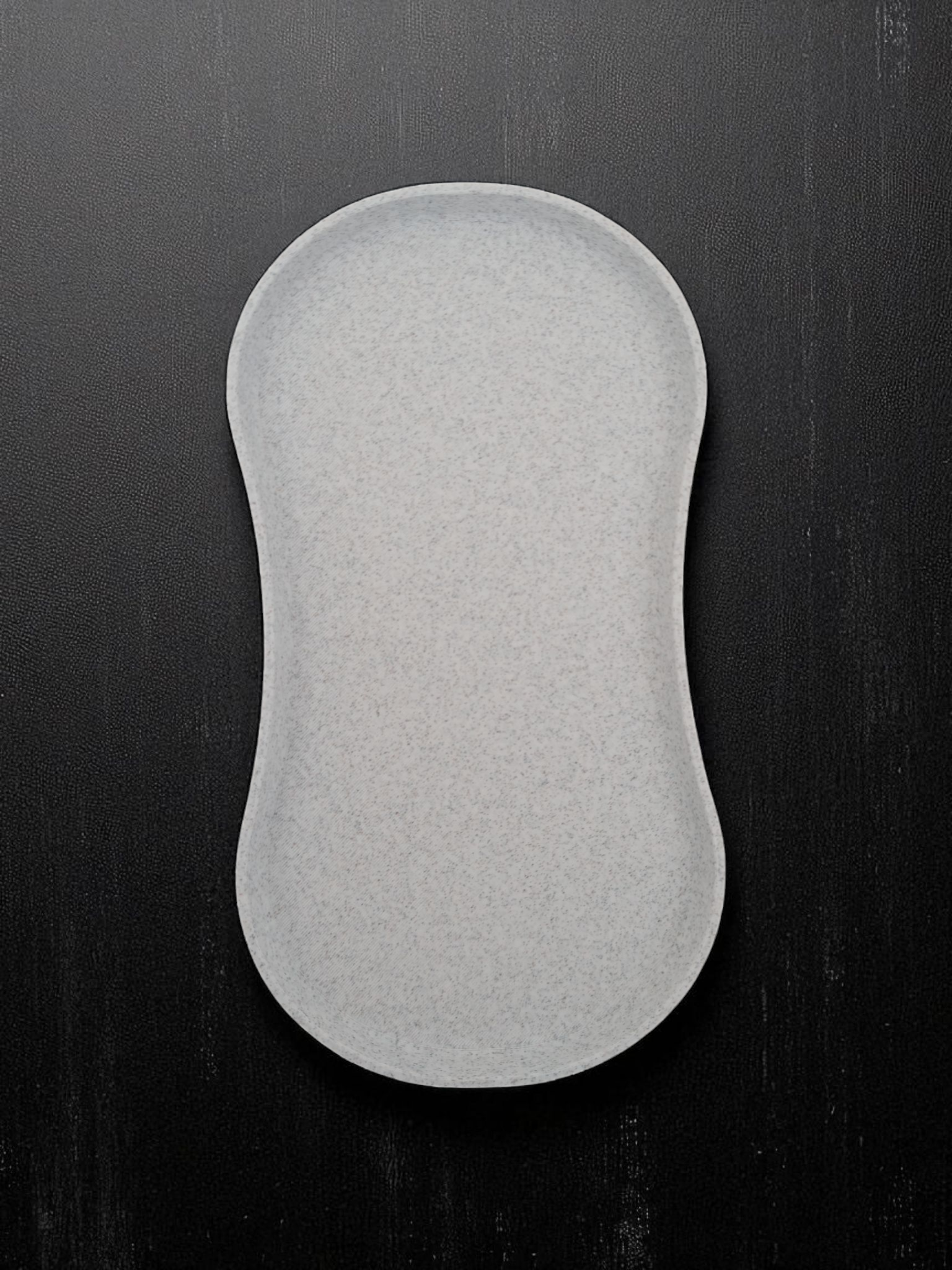 Minimalist white spoon rest with shallow tray design, close-up view