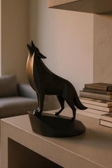 Close-up of minimalist wolf sculpture showing geometric planes and open mouth detail