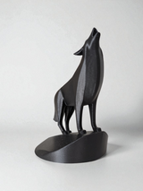 Close-up of minimalist wolf sculpture showing geometric planes and open mouth detail