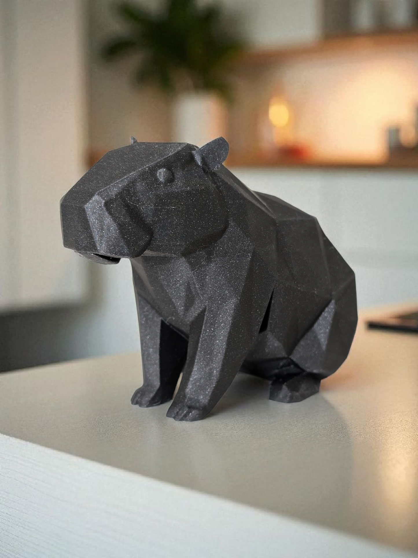 Low poly capybara sculpture showing geometric faceted surface and calm posture