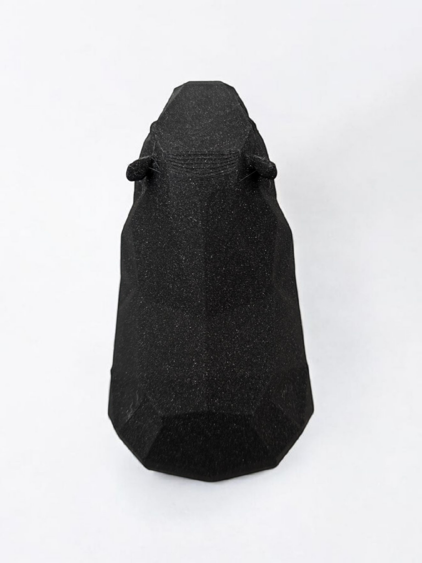 Low poly capybara sculpture showing geometric faceted surface and calm posture