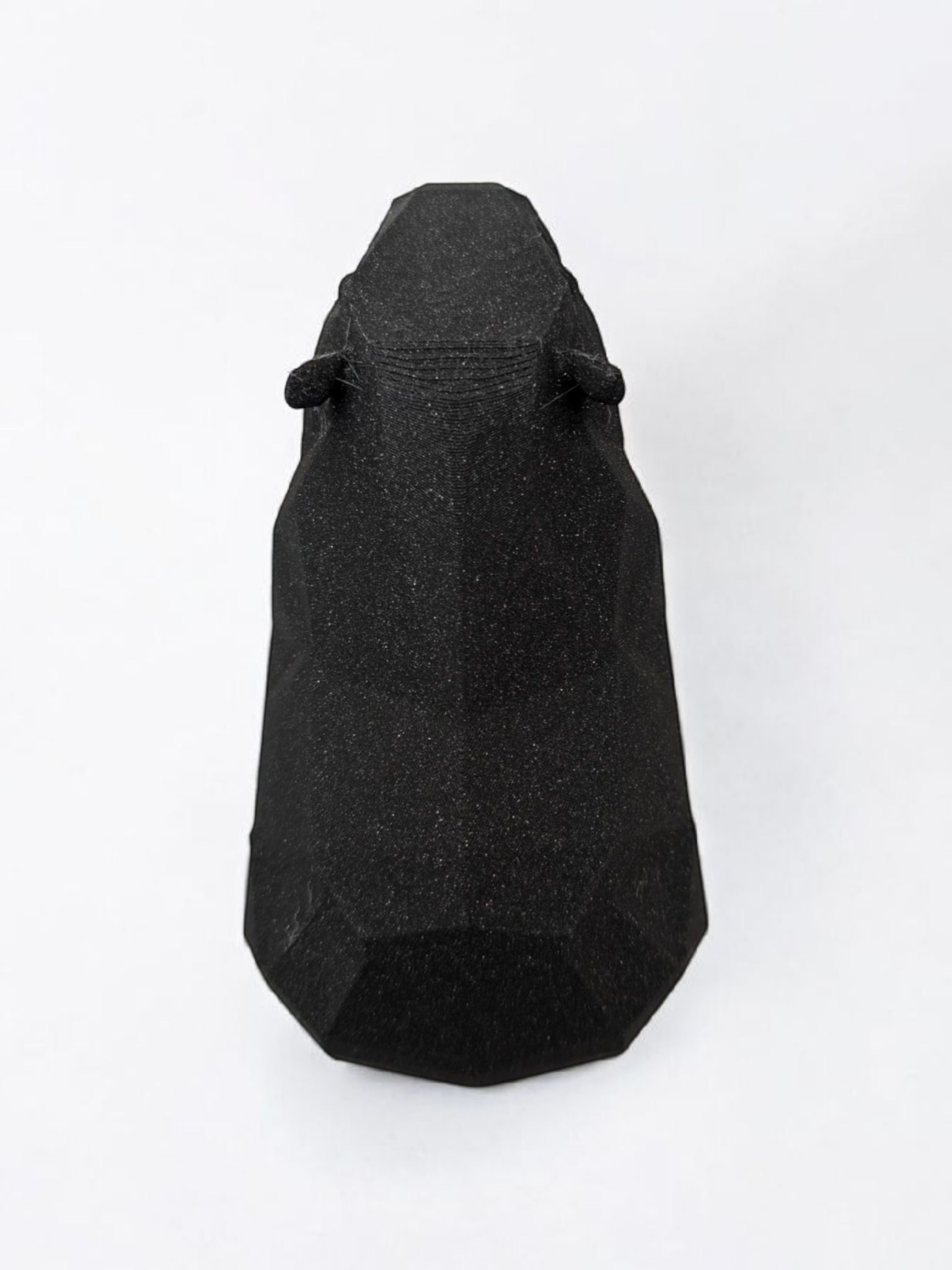 Low poly capybara sculpture showing geometric faceted surface and calm posture