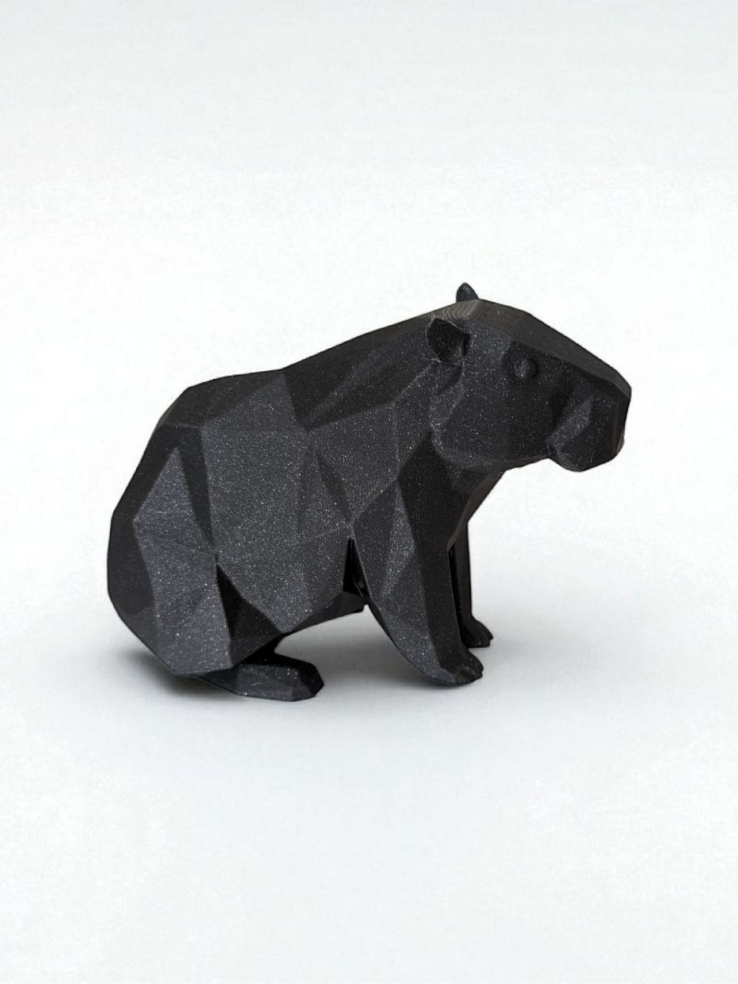 Low poly capybara sculpture showing geometric faceted surface and calm posture