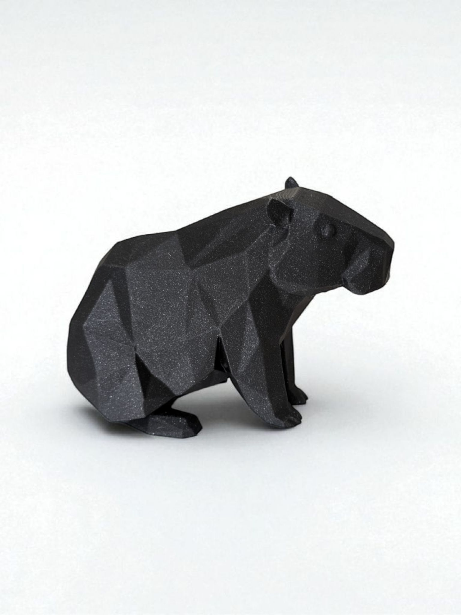 Low poly capybara sculpture showing geometric faceted surface and calm posture